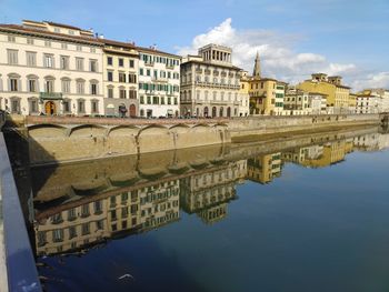 A row of attached four storey buildings along a river margin