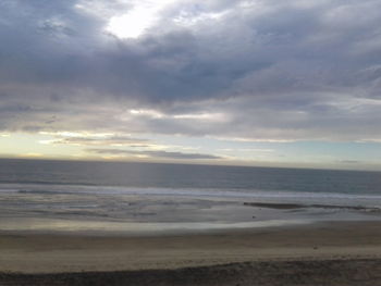 Scenic view of beach against sky during sunset