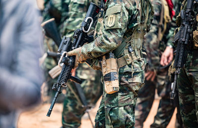 Soldiers with weapons on military combat training