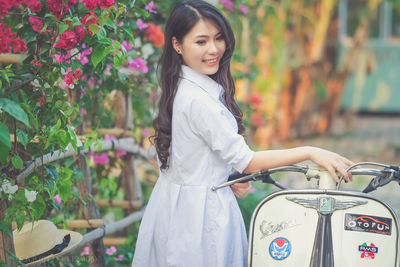 Portrait of a young woman standing outdoors