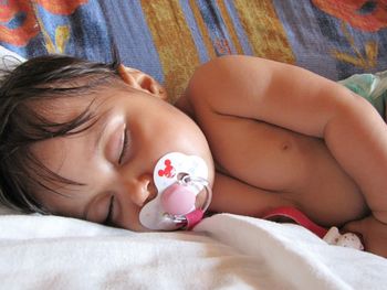 Young woman sleeping on bed