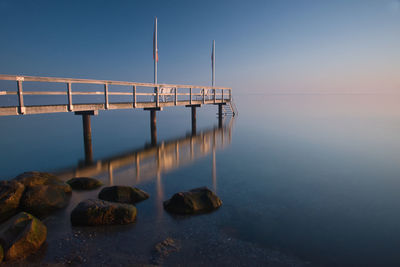 Scenic view of sea against clear sky during sunset