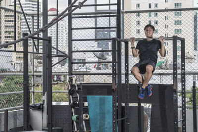 Man training at rooftop gym in bangkok