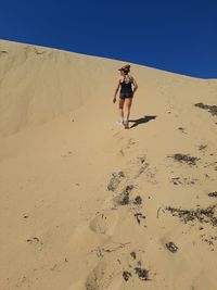 Low angle view of people on sand at beach