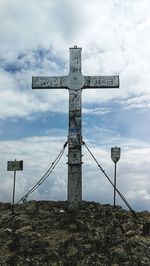 Low angle view of cross against sky