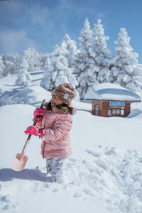 Full length of woman standing on snow