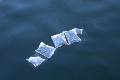 High angle view of plastic floating on water