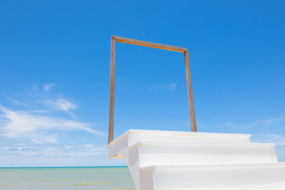 Low angle view of sea against blue sky