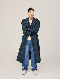 Portrait of teenage girl standing against white background