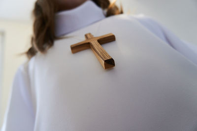 Low angle view of woman wearing cross pendant