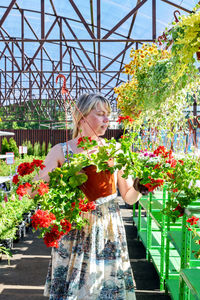 Florists woman working with flowers at a greenhouse.