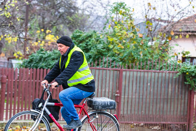 Side view of man riding bicycle