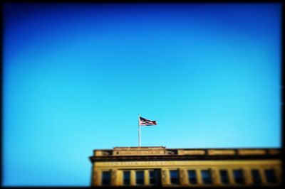 Low angle view of buildings against clear blue sky