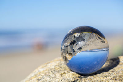 Close-up of crystal ball on rock
