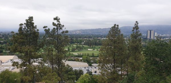 High angle view of trees and buildings against sky