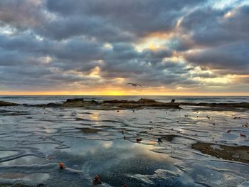 Scenic view of sea against cloudy sky