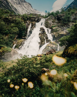 Scenic view of waterfall against sky