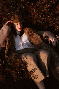 High angle view of young woman lying down on field