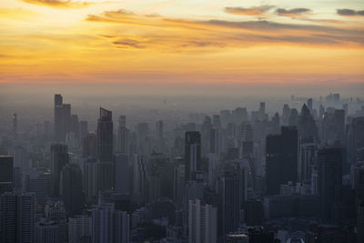 Aerial view of cityscape against sky during sunset