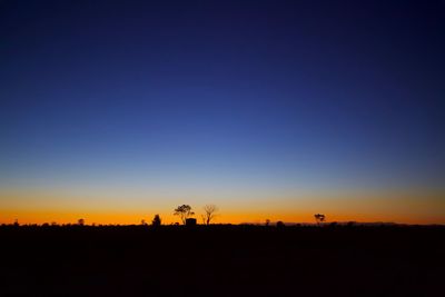 Scenic view of silhouette landscape against clear sky during sunset