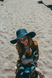 Portrait of smiling woman sitting on beach