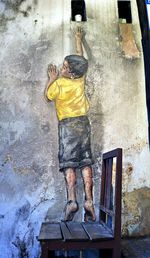 Full length of man painting on wall