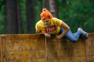 Portrait of woman sitting on wood