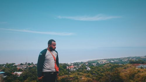 Full length of man standing on mountain against sky