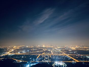 High angle view of illuminated city buildings at night