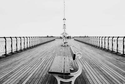 Pier over sea against clear sky