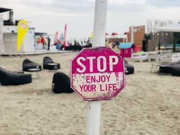 Information sign on pole at beach