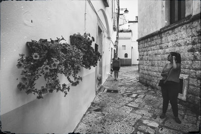 Rear view of woman walking on alley