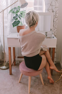 Boy holding chair at home