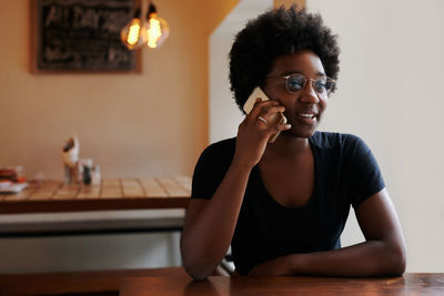 Portrait of smiling woman sitting at home