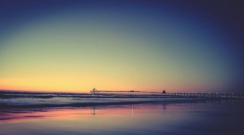 Scenic view of sea against clear sky during sunset