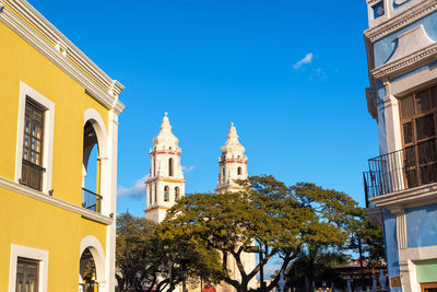 Low angle view of cathedral against blue sky during sunny day