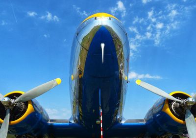 Close-up of airplane wing against sky