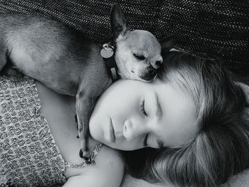 Girl and dog sleeping in bed