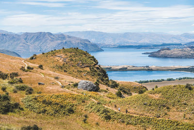 Scenic view of sea and mountains against sky