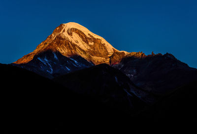 Scenic view of mountain range against clear blue sky