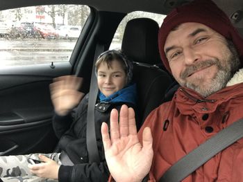 Portrait of smiling man sitting in car