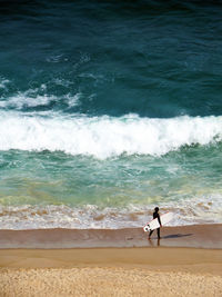 Surfer walking at beach