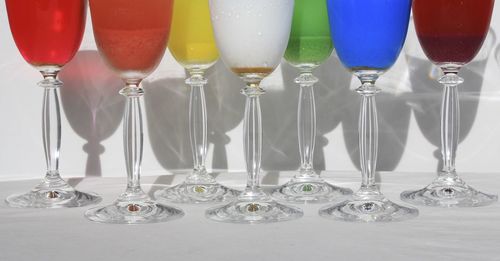 Multi colored wineglasses arranged on table