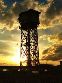 Low angle view of built structure against sunset sky