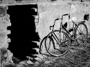 Bicycle parked in front of wall