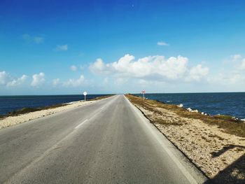 Road by sea against sky