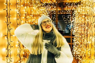 Portrait of young woman standing at night