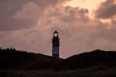 Low angle view of lighthouse against sky during sunset