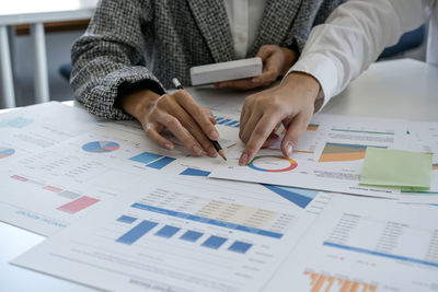 Midsection of businessman working at office