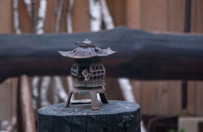 Close-up of small wooden post in fence